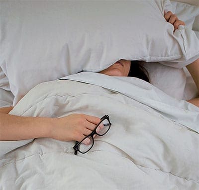 Debilitated woman laying in bed. Jillian, Stenberg's Psychiatric Nursing student, learnt the importance of healing while sick in bed.