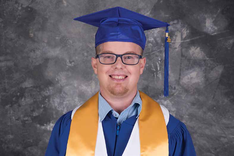 Scott smiles on his grad gown. As a Mental Health and Addictions worker he'll be able to help people.