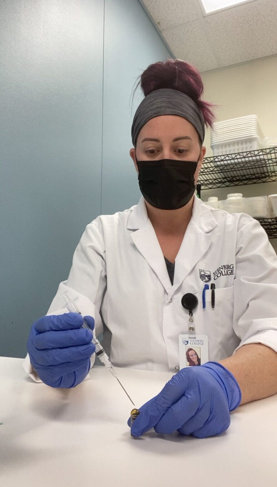 Sheri training to use a syringe