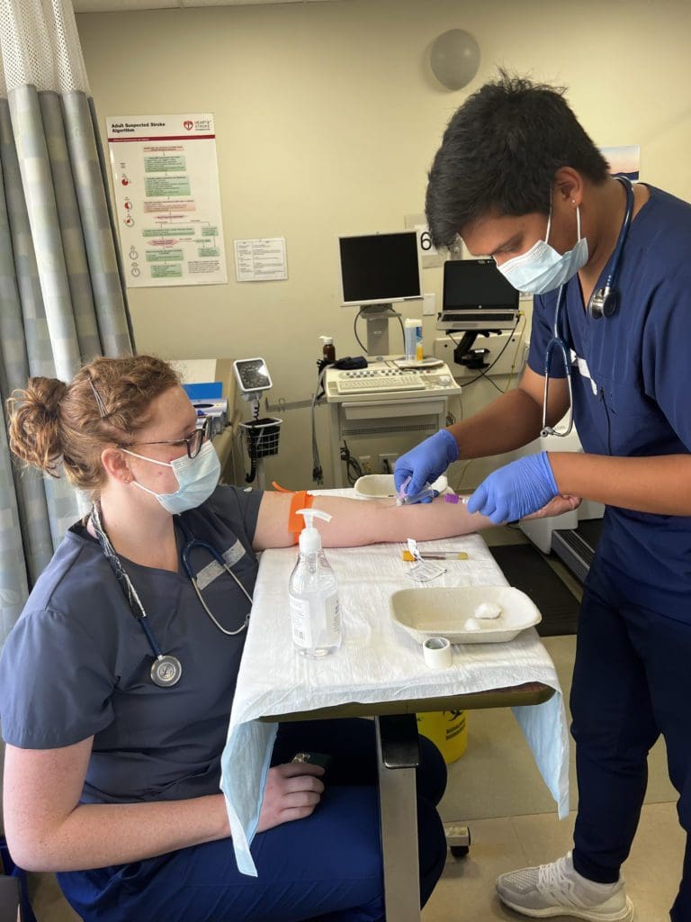 Taryn and Mark practicing venipuncture skills