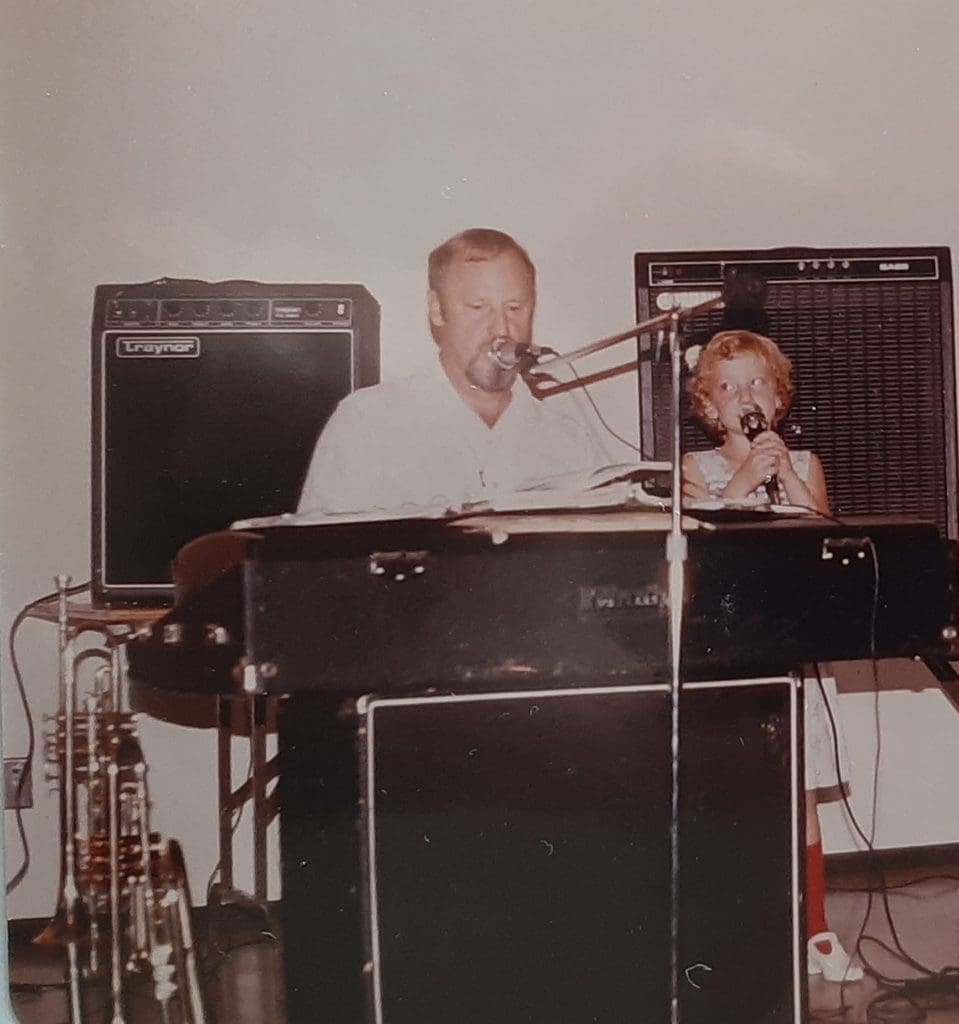 A young Natasha and her dad during a performance