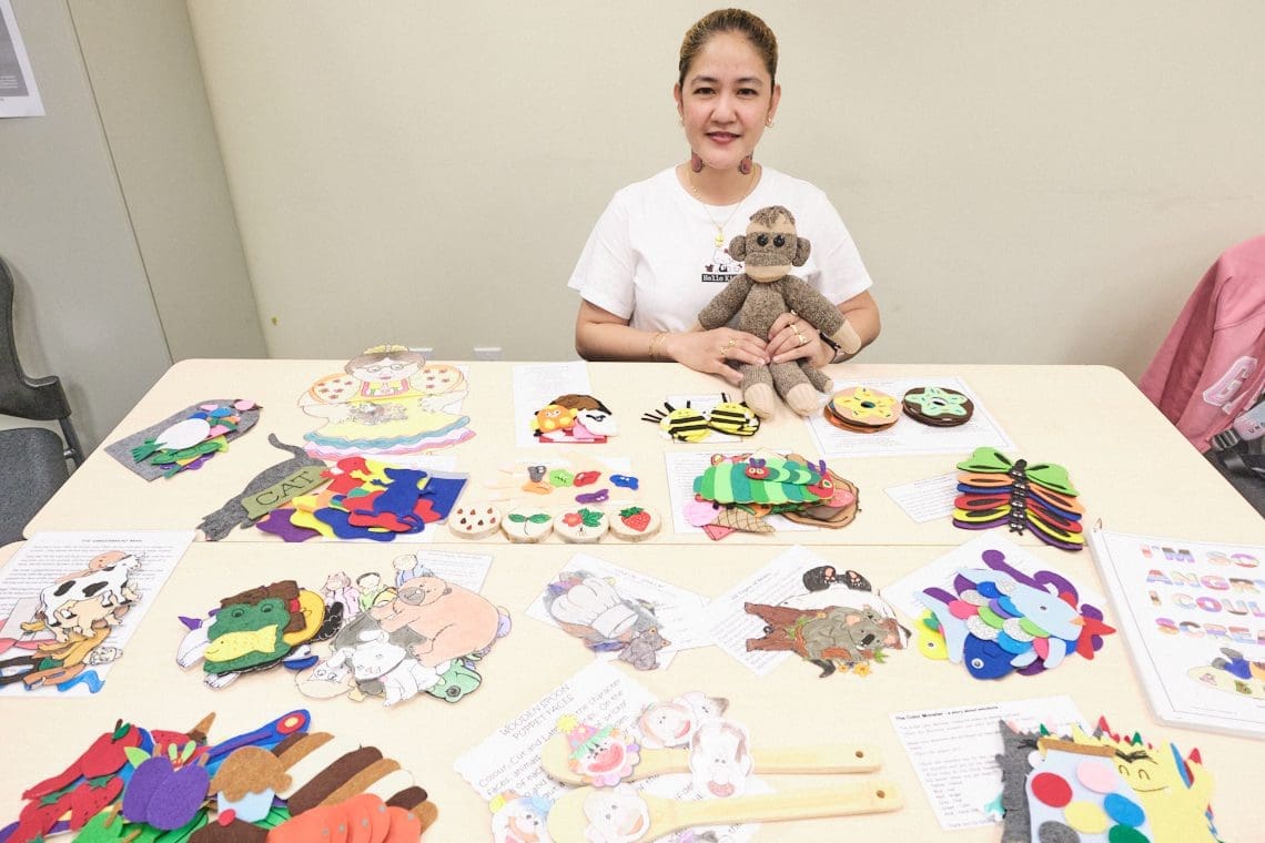 Ronette Arellano displaying the resources she made in ECE program