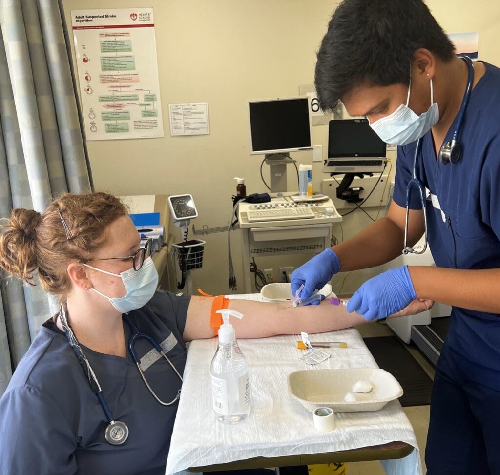 Taryn Rowland practices phlebotomy as part of her lab experience.