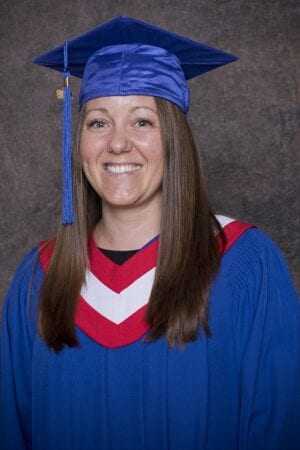 Debra Andrew can't hide her happiness while wearing a graduation gown after completing her Psych Nursing course at Stenberg.