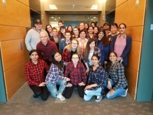 Faith and her classmates of the Education Assistant Program standing proudly in front of Stenberg College's Campus.