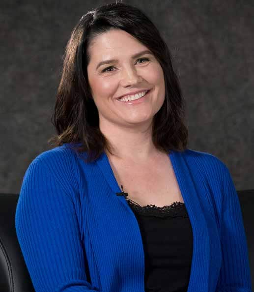 Melanie smiles to the camera. She overcame years of difficulties and started her dream career as a Practical Nurse.