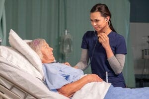 Nurse and Resident. During the first clinical as a Practical Nursing, students learn the tasks they'll be performing at a Care Facility.